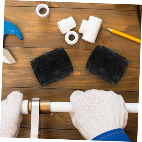 Two Piece Pro Grade Reamer Deburring Tool Set for water and copper pipes on a wooden table, with gloved hands holding a pipe.