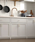 Modern kitchen cabinetry featuring Ten Pack Center Mount Cabinet Knobs And Barrel Drawer Pulls In Matte Black With Gold Accents.