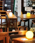 Ultra Fun Waterproof 10 Inch RGB LED Ball Light Orb With Remote Control illuminating on tables indoors