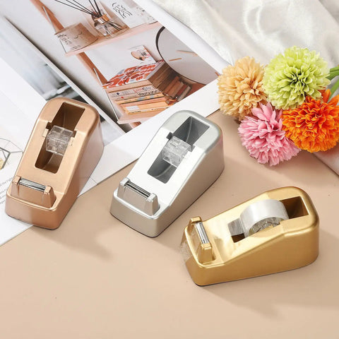 Heavy Duty Frosted Tape Dispenser Slick Non Skid Desk Holder Built Tough For One Hand Snipping Silver Plastic Organizer on a beige table.