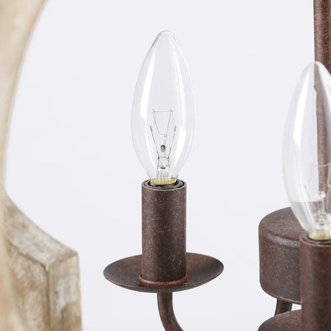Bulb detail of Rustic Wood Farmhouse Chandelier Four Light Hanging Ceiling Fixture For Dining Room, Living Room, Bedroom, And Hallway Handmade Openwork Quatrefoil Design With Warm Rust Metal Finish And Modern Classic Appeal