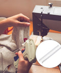 Top Rated 5000 Piece Plastic Tagging Gun Fasteners 0.5 Inch White Barbs in use with a tagging gun on clothing.