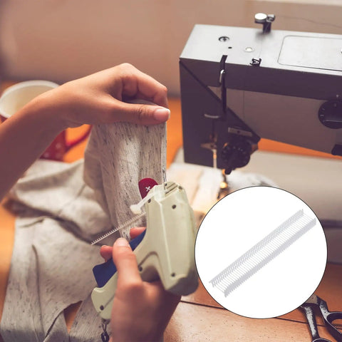 Top Rated 5000 Piece Plastic Tagging Gun Fasteners 0.5 Inch White Barbs in use with a tagging gun on clothing.