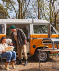 Multi Fuel Outdoor Pizza Oven For Wood And Gas With 12 Inch Pizza Stone And Integrated Thermometer next to camper van.