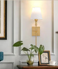 Wireless Battery Operated Wall Sconce Set Of 2 With Remote, gold finish, indoor fabric shade in a stylish living room decor