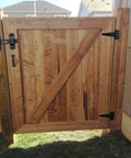 Wooden gate with self-closing gate latch kit, tee hinge, 4-inch T-strap hinges in black finish. Ideal for wood or vinyl fences.