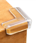 12 Pack Transparent Corner Protectors For Tables And Desks Soft Pvc Furniture Edge Bumpers on a wooden table corner.