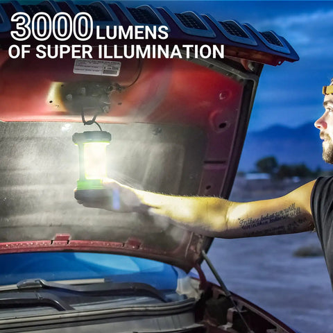 Man using 3000LM Rechargeable Camping Lantern With 5 Light Modes Waterproof COB Dual Panels under car hood at dusk