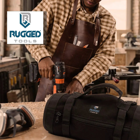 Person in workshop with apron using drill, Titan23-XL Tool Roll And Organizer For Electricians, HVAC Techs, Plumbers nearby on table