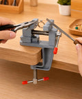 Zero Drama Mini Bench Vise Sturdy Table Mount Badass High Carbon Steel Adjustable Clamp holding a ring for jewelry making.