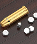 Red Laser Bore Sight For .357 Magnum And .38 Special with brass body and batteries on wooden surface