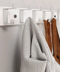 Slick Modern Wall Mounted Coat Rack In Brushed Brass With Heavy Duty Hooks For Entryway Living Room Or Kitchen To Hold Jackets Bags Hats And Umbrellas No Fuss Ever Durable Finish Looks Sharp While Sorting Daily Items Straight Up, featuring gray and brown items hanging.