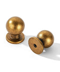 Two 1-inch antique brass zinc alloy cabinet knobs, single hole, focus on both top and base, part of 25 Pack 1 Inch Vintage Retro Antique Brass Zinc Alloy Cabinet Knobs With Single Hole Center Built To Last Solid Heavy Duty Hardware Pulls For Bedroom Kitchen And Home Makeover.