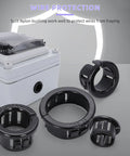 DIY Friendly 50 Pack Black Snap-In Bushing Grommets for Wiring and Tubing next to electrical enclosure