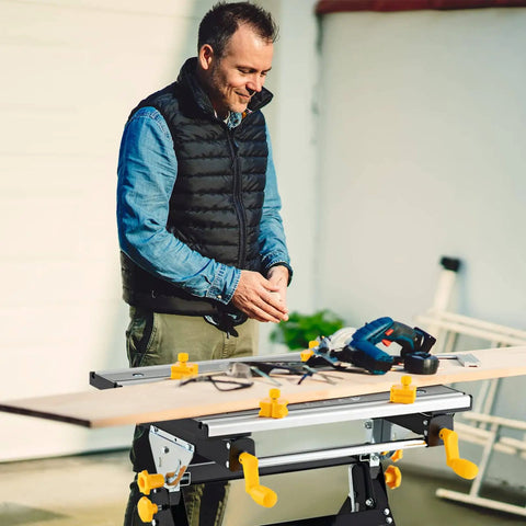 Man using Portable Folding Workbench With Vise And Eight Sliding Clamps Seven Level Height Adjustments Tiltable Extendable Tabletop