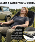 Woman relaxing on Two Pack Oversized Padded Camping Chair Heavy Duty Quad Fold Arm Chair Portable For Outdoor Use Supports Up To 500 Lbs With Diamond Quilted Cushion For Beastly Comfort Black in a field