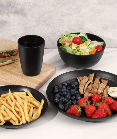 Unbreakable 24 Piece Dinnerware Set For Six With Plates Bowls And Cups, lightweight black plates with food displayed