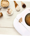 Stirring Paddle Replacement For Bread Maker Reusable Kneading Mixer Blade Spare Part visible on bread machine with ingredients