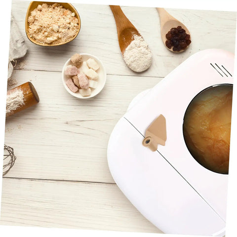 Stirring Paddle Replacement For Bread Maker Reusable Kneading Mixer Blade Spare Part visible on bread machine with ingredients