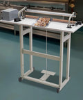 Rock Solid Foot Pedal Heat Sealing Machine And Impulse Sealer For Commercial Plastic Bags with sealed snacks on packing table.
