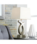 Modern 28 Inch Art Sculpted Table Lamp Two Pack in Silver Finish With White Rectangular Shade Resin Base in living room setting