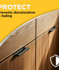 Revive Your Wood Furniture And Kitchen Cabinets With This Deep Cleaning Polish Bundle That Sweeps Away Grime Dust And Scratches While Locking In A Glossy Finish With UV Protection, close-up of wooden cabinet with black handles.