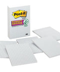 Sticky Grid Notes 4x6 Inches, 6 Pads With 50 Sheets Each, White Paper With Blue Grid, scattered beside packaging