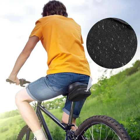Cyclist riding with Under Seat Bike Bag Waterproof Ride Ready Saddle Pouch for travel, highlighted waterproof fabric inset.