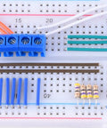 Close-up of a breadboard with blue connectors and resistors from 560 Piece Jumper Wire Kit With 14 Lengths Of Assorted Preformed Breadboard Wires.