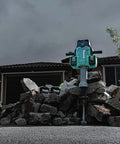 Badass Heavy Duty Eighty Volt Brushless Cordless Breaker Hammer With Seventy Foot Pounds Of Knockout Chisel Power and One One Eighth Inch Hex Shank AVT Anti Vibration AWS Compatible Demolition Kit featuring a heavy-duty hammer positioned on a pile of concrete rubble.