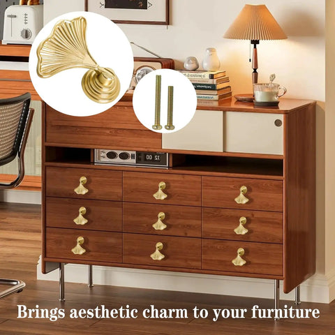 Image of 4 Piece Dope Golden Leaf Knob Set For Cabinets And Drawers on wooden furniture, highlighting metal handles and included installation screws.