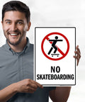 Man holding No Skateboarding Sign 10x14 Inches Built From Rust Free Aluminum Weatherproof Fade Resistant Outdoor Sign For Shops Yards