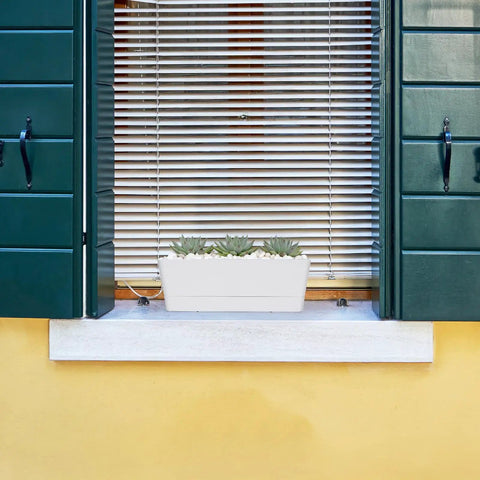 16 Inch Window Box Planter With Tray Lightweight Plastic Rectangular Pot For Balcony Or Windowsill Great For Herbs Succulents Cacti Flowers Or Faux Plants With Drainage Holes And Attached Saucer installed on a windowsill