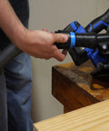 Person connecting hose to power tool with Assembled Quick Click Dust Separator And 5 Gallon Locking Collection Bin With Caster Dolly