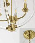 Modern Four Light Pendant Chandelier With Clear Acrylic Globes And Brass Finish in dope farmhouse style close-up with chain detail