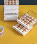 32 Capacity Egg Holder For Fridge With Time Scale Two Drawer Egg Storage Container Organizer Bin Keeps Eggs Fresh And Easy To See And Grab In Your Kitchen, clear plastic with eggs on yellow background