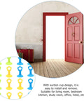 Sixteen Pack Silicone Door Stopper with Suction Cup, assorted colors, shown on red door to prevent wall damage