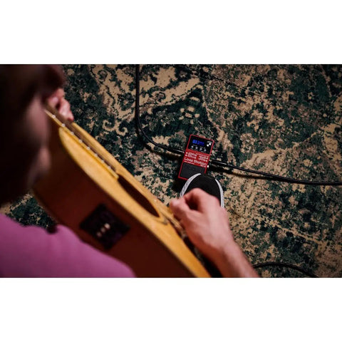 Musician using RC-5 Loop Station: Compact Pedal for Next-Level Looping, 32-Bit AD-DA and Floating-Point Processing on a carpeted floor