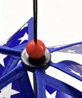 Close-up of All American Patriotic Wind Spinner Duo with blue blades and white stars, featuring a red bead center.
