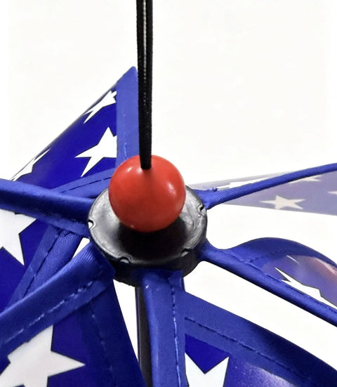 Close-up of All American Patriotic Wind Spinner Duo with blue blades and white stars, featuring a red bead center.