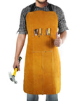 Heavy Duty Leather Welding Apron, Flame and Spark Resistant Bib, Safety Smock for Blacksmiths Welders and Woodworkers, 23x35 Inches, Full Knee Coverage, Durable Fireproof Stitching worn by a person holding tools.
