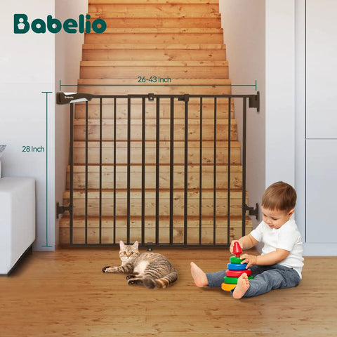 Auto Close Baby and Dog Gate for Stairs and Hallways 2 In 1 Swing Doorway and Hallway Pet Gate With Extra Wide Walk Through Door and Threshold Free Design Black blocking stairs with a cat and baby playing nearby.