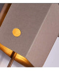 Close-up of the Top Shelf Modern LED Wall Sconce showcasing leather and gold accents, ideal for relaxed living rooms.