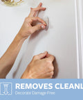 Hands removing small clear hook with adhesive from wall, Damage Free Hanging For Small Wall Hooks Clear Refill Adhesive Strips Pack Of 16 Ideal For Dorm Room Decor No Holes Or Residue Hassle Free Easy Setup Removable And Repositionable For A Quick Space Makeover.