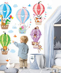 Child pointing at 2-sheet hot air balloon wall decals with cute animal cloud stickers, nursery playroom decor, easy peel and stick.