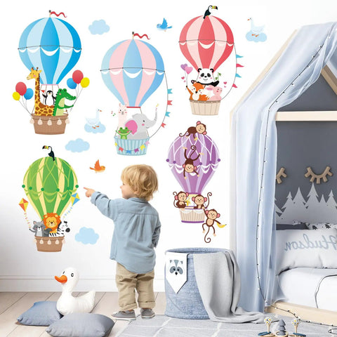 Child pointing at 2-sheet hot air balloon wall decals with cute animal cloud stickers, nursery playroom decor, easy peel and stick.