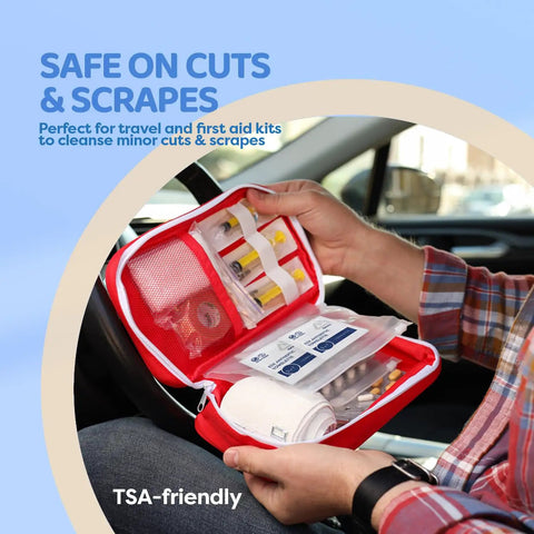 Person holding first aid kit open in car showing antiseptic towelettes for minor cuts, next to medical supplies and instructions.