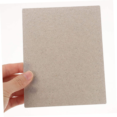 Hand holding Heat Resistant Microwave Mica Sheet from 10-piece set, adjustable size, for waveguide covers in kitchen accessories