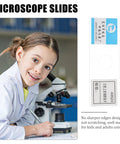 Young student using microscope with 5 Ready To Use Microscope Slides With Oral Epithelial Cells For Biology Education And Lab Experiments Perfect Teaching Props For High School And Middle School Science Classes.