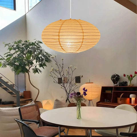FEHEED 16 Inch Oval Plug in Hanging Paper Lantern Lights with Cord illuminating a stylish dining area with plants.